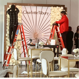 Charlotte Tilbury Branding Installation, Installation Crew installs a Branded Event Panel